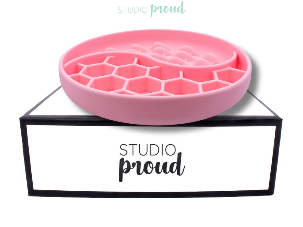 Pink anti-slip slowfeeder for dogs on a Studio Proud box.