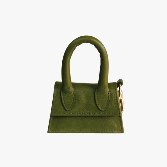 Green designer bag for dog treats and waste bags, sleek and functional pet accessory.